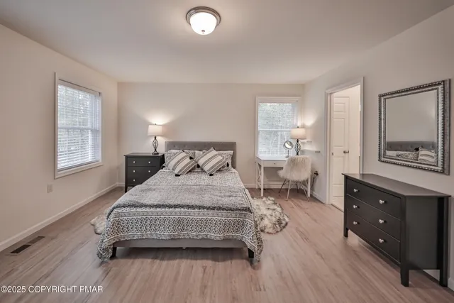 a bedroom with a bed and a night stand