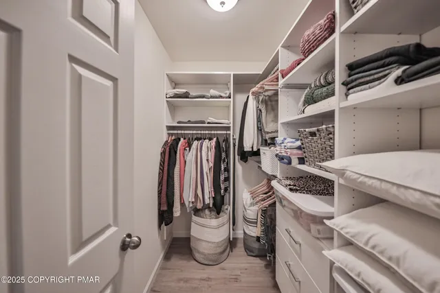 a view of a hallway with wooden floor and stairs