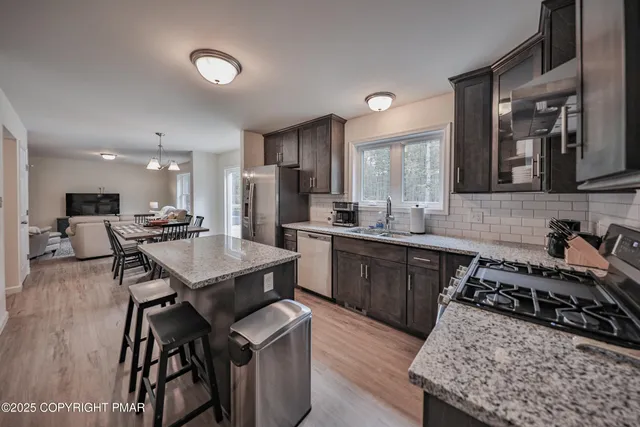 a kitchen with a sink stove and refrigerator