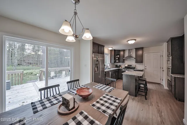 a living room with furniture a flat screen tv and a large window