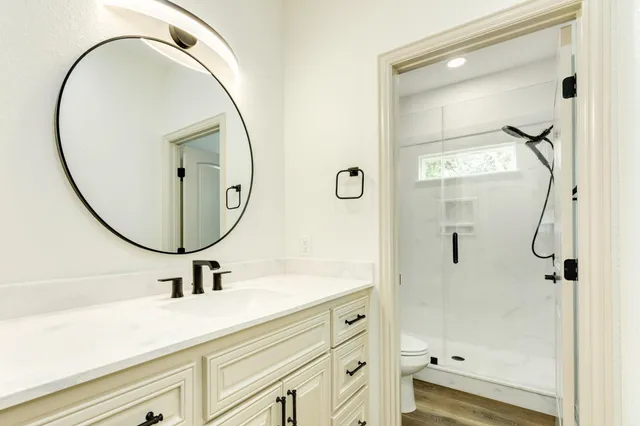 a bathroom with a sink a mirror a vanity and a mirror