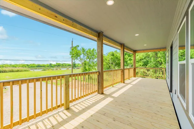 a view of balcony with wooden floor