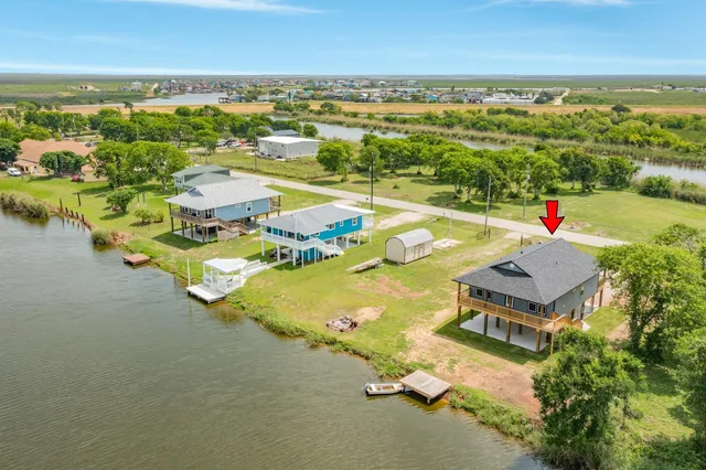an aerial view of residential houses with outdoor space