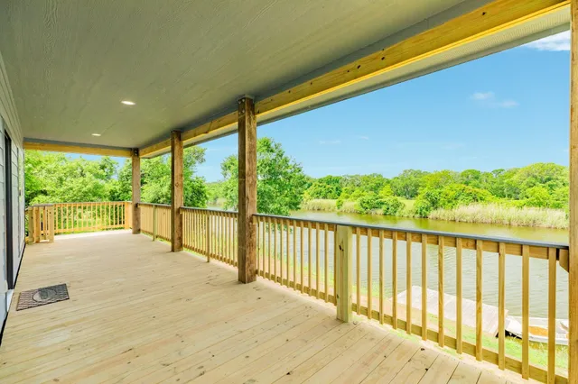 a view of balcony with floor to ceiling windows with wooden floor