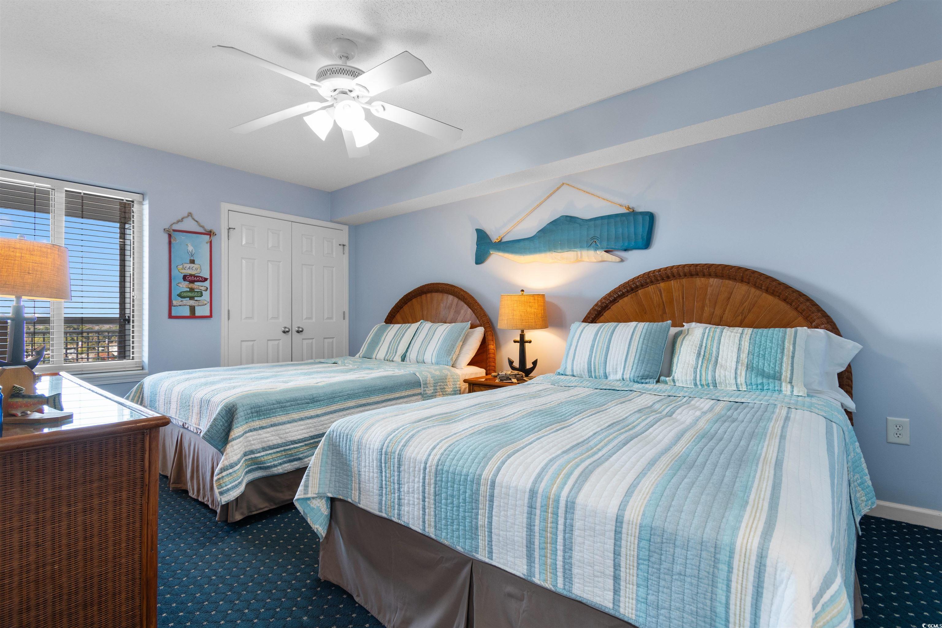 1625 South Ocean Boulevard, Unit 1603 North Myrtle Beach, SC 29582 - Photo 15 of 39 Bedroom featuring a closet, a ceiling fan, and carpet floors