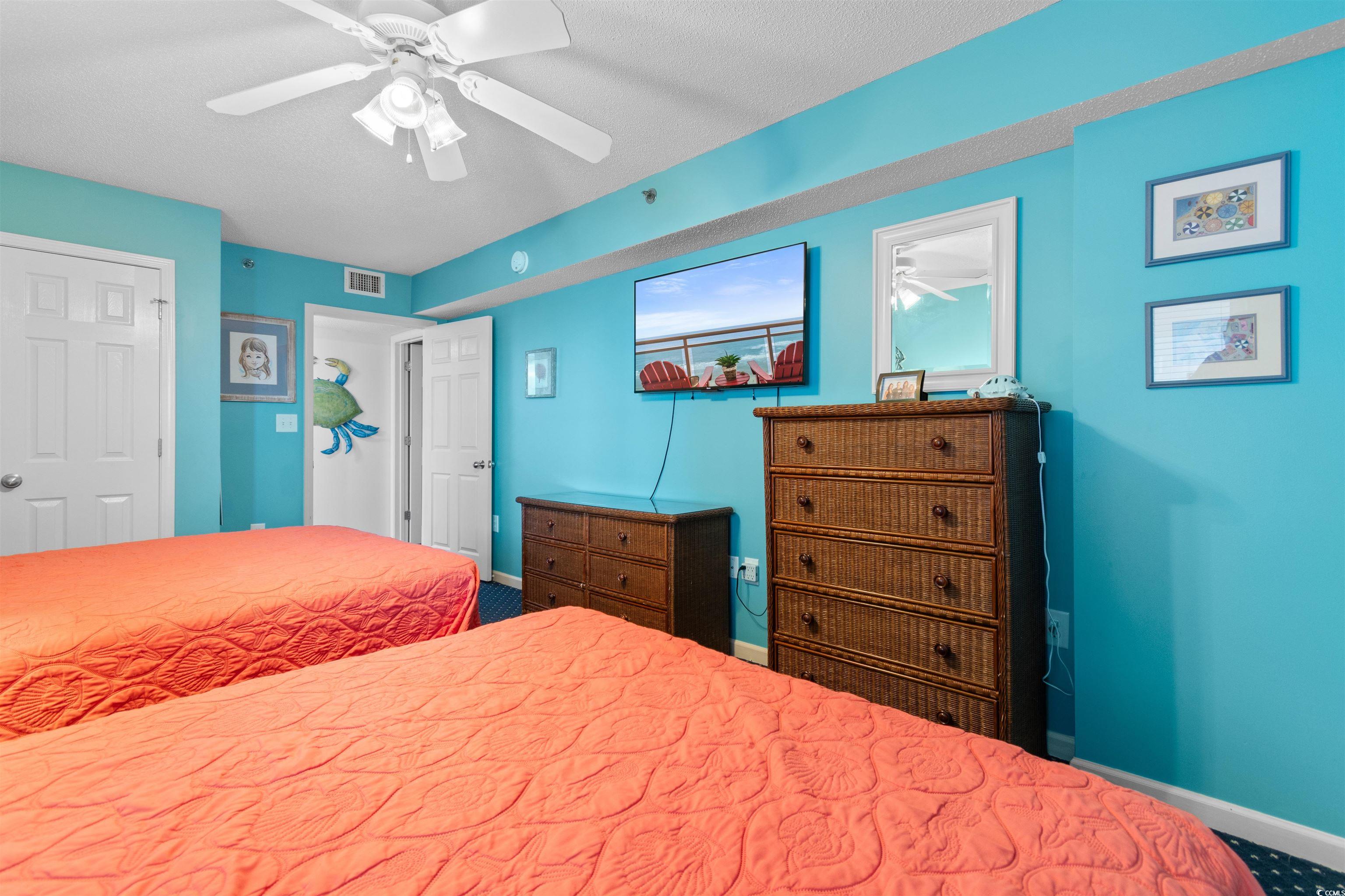 1625 South Ocean Boulevard, Unit 1603 North Myrtle Beach, SC 29582 - Photo 21 of 39 Bedroom with a ceiling fan, a closet, and a textured ceiling