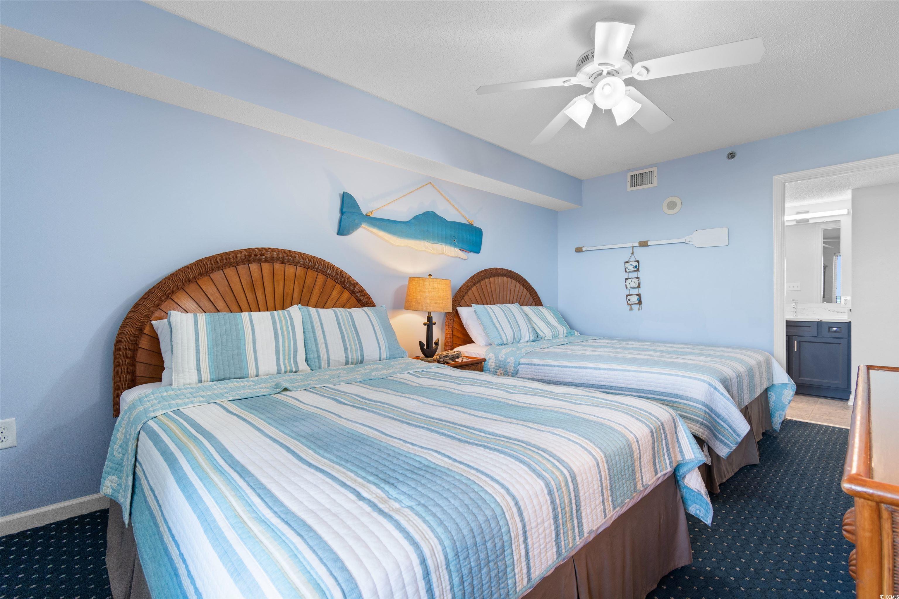 1625 South Ocean Boulevard, Unit 1603 North Myrtle Beach, SC 29582 - Photo 23 of 39 Bedroom with dark colored carpet, ceiling fan, and ensuite bath