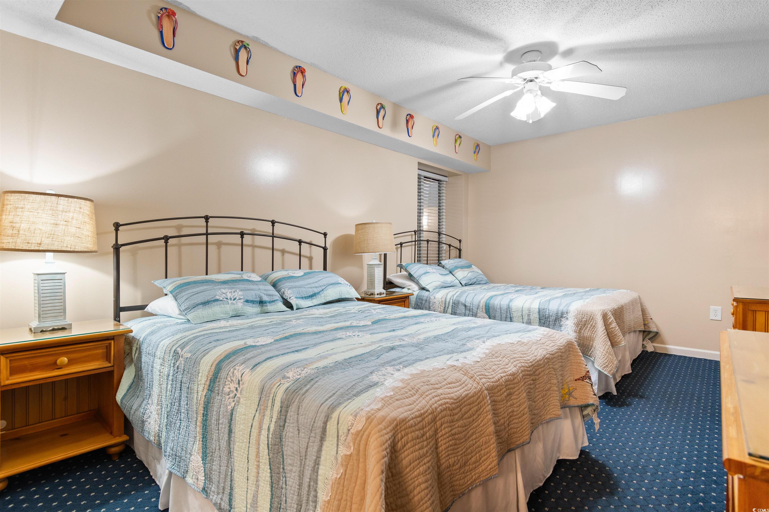 1625 South Ocean Boulevard, Unit 1603 North Myrtle Beach, SC 29582 - Photo 24 of 39 Carpeted bedroom with a textured ceiling and a ceiling fan