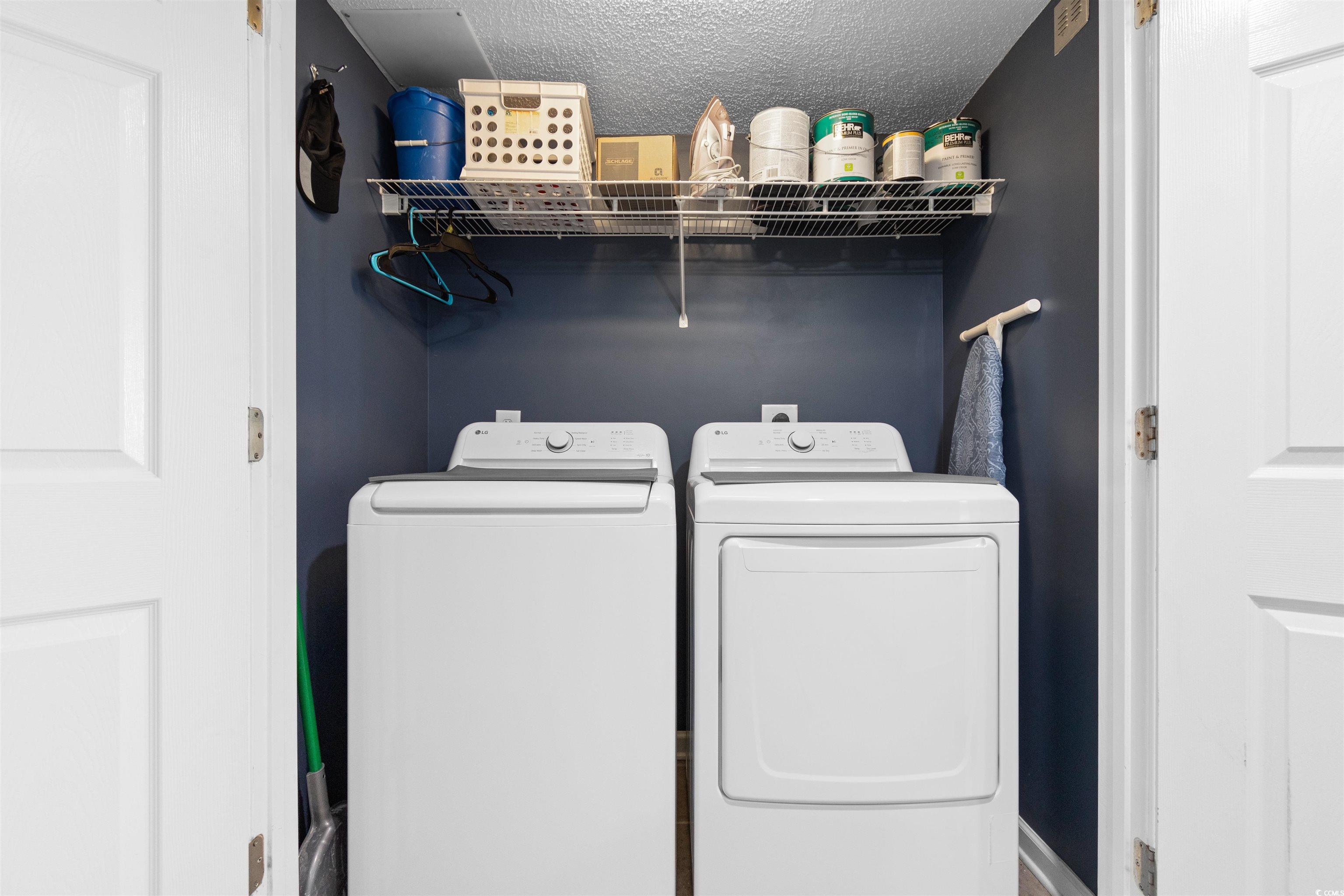 1625 South Ocean Boulevard, Unit 1603 North Myrtle Beach, SC 29582 - Photo 27 of 39 Washroom with washing machine and dryer and a textured ceiling