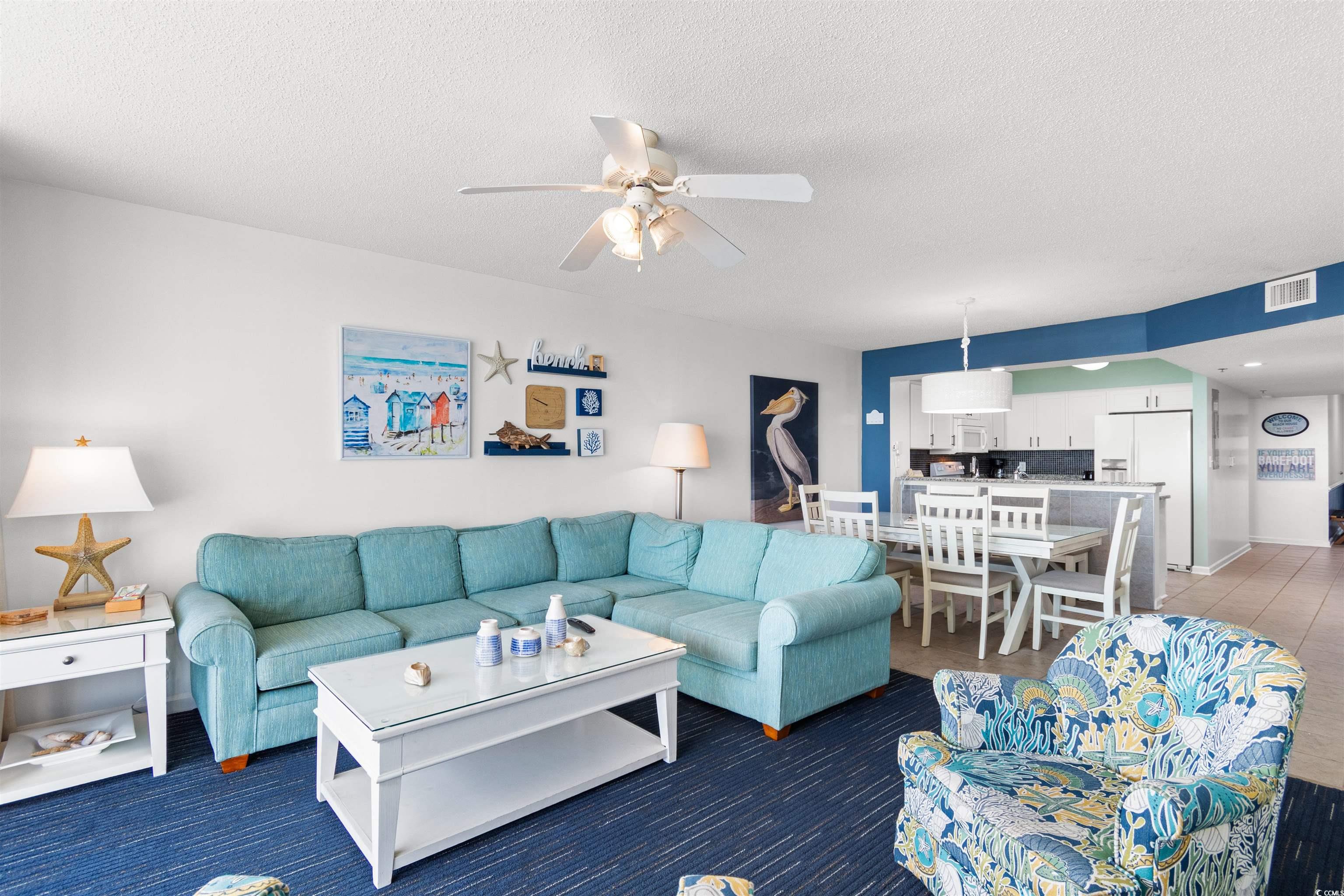 1625 South Ocean Boulevard, Unit 1603 North Myrtle Beach, SC 29582 - Photo 3 of 39 Living area featuring ceiling fan and a textured ceiling