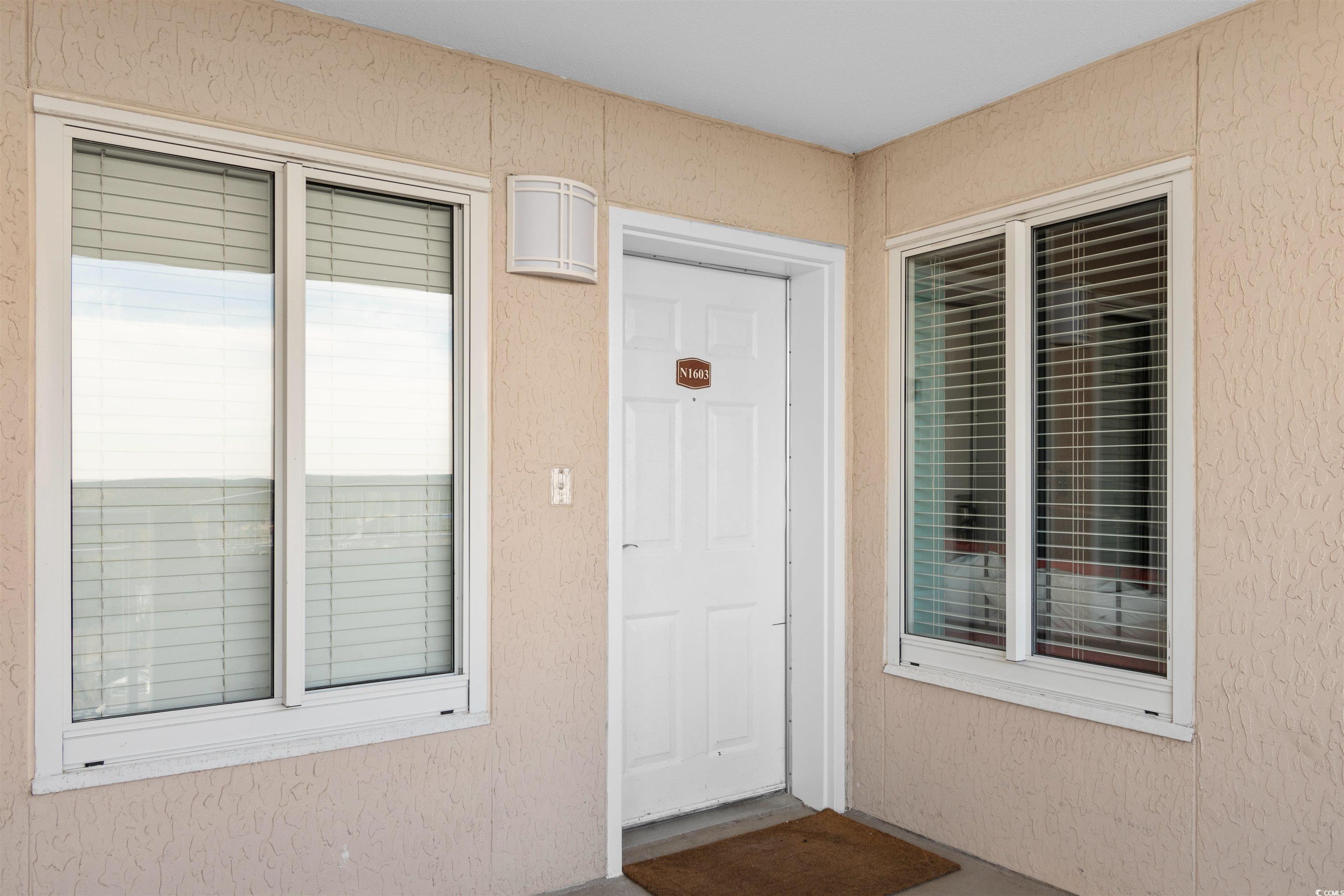 1625 South Ocean Boulevard, Unit 1603 North Myrtle Beach, SC 29582 - Photo 32 of 39 Doorway to property featuring stucco siding