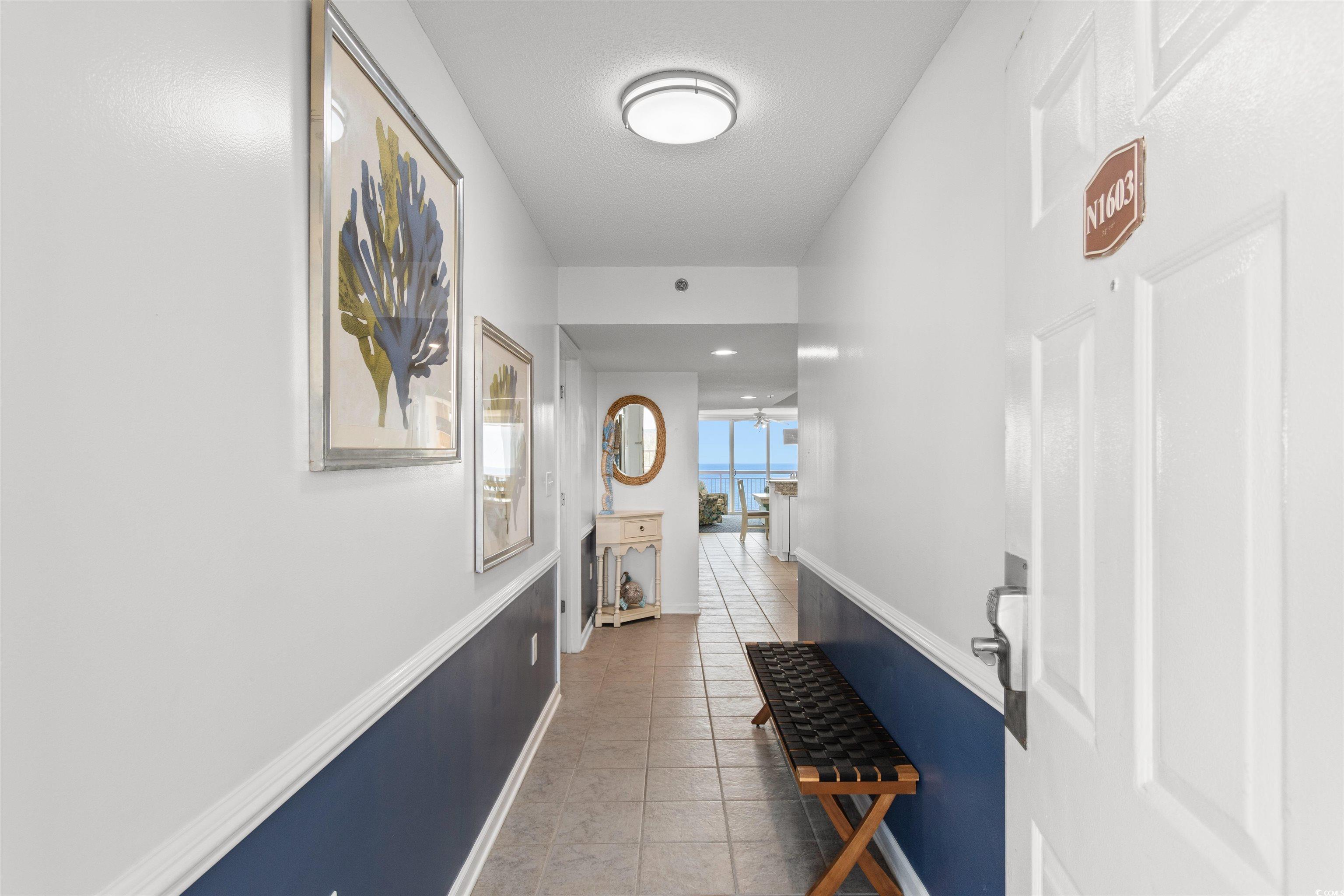1625 South Ocean Boulevard, Unit 1603 North Myrtle Beach, SC 29582 - Photo 33 of 39 Corridor featuring light tile patterned floors and baseboards