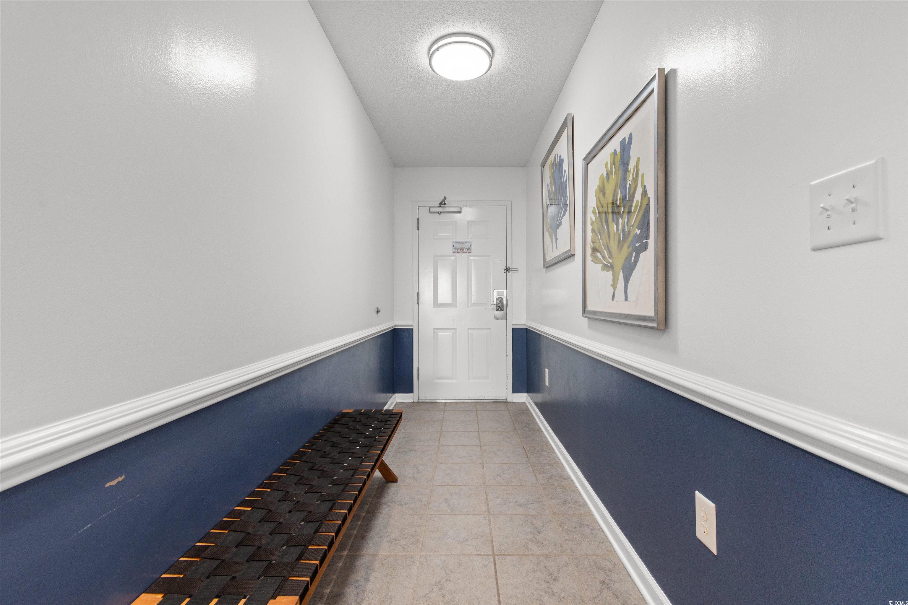 1625 South Ocean Boulevard, Unit 1603 North Myrtle Beach, SC 29582 - Photo 34 of 39 Doorway featuring tile patterned flooring and a textured ceiling