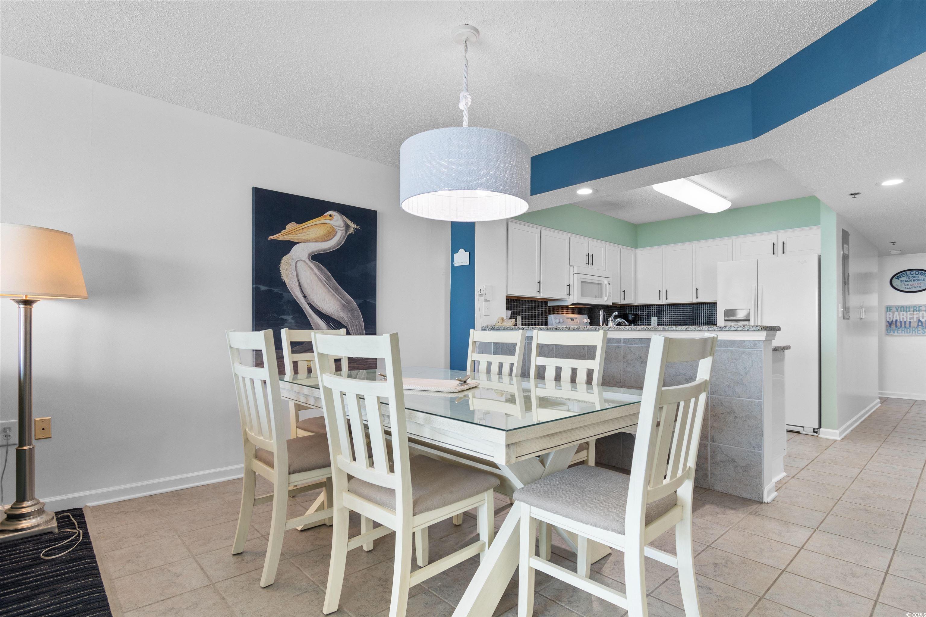 1625 South Ocean Boulevard, Unit 1603 North Myrtle Beach, SC 29582 - Photo 7 of 39 Dining area featuring light tile patterned flooring, recessed lighting, and a textured ceiling
