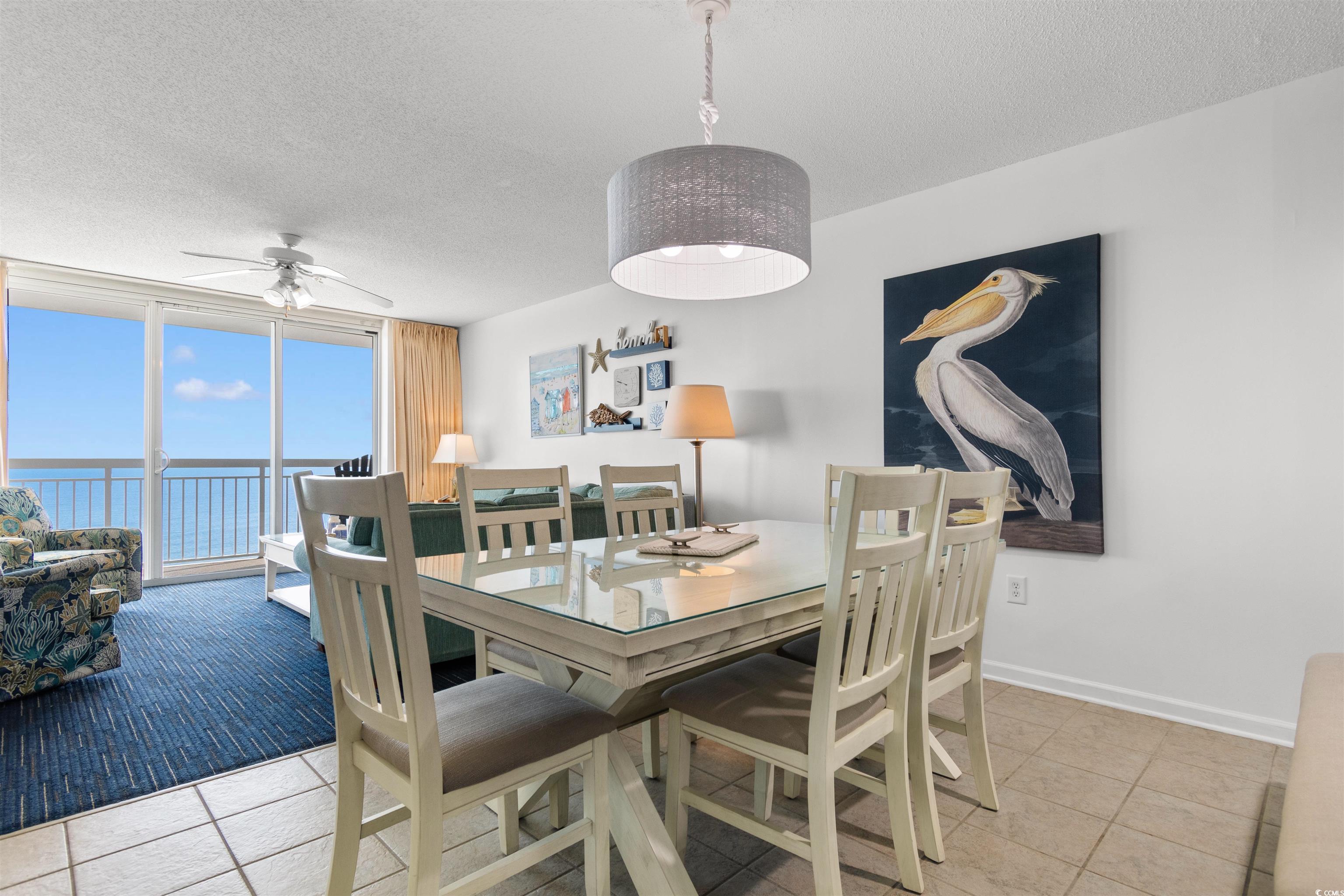 1625 South Ocean Boulevard, Unit 1603 North Myrtle Beach, SC 29582 - Photo 8 of 39 Dining space featuring a textured ceiling, light tile patterned flooring, floor to ceiling windows, a water view, and a ceiling fan