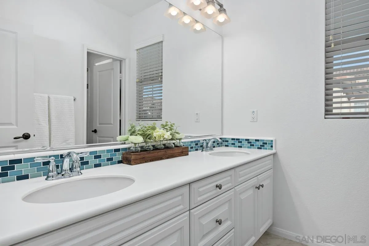 8458 Christopher Ridge Terrace San Diego, CA 92127 - Photo 11 of 41 a bathroom with a granite countertop sink and a mirror