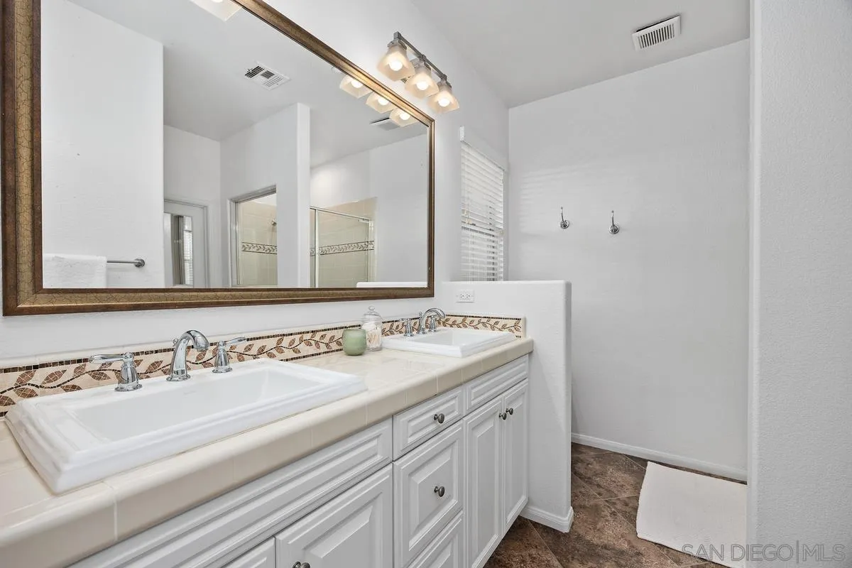 8458 Christopher Ridge Terrace San Diego, CA 92127 - Photo 19 of 41 a bathroom with a sink and a mirror