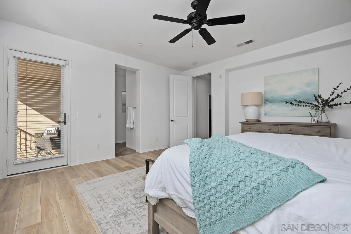 8458 Christopher Ridge Terrace San Diego, CA 92127 - Photo 20 of 41 a bedroom with a bed and a painting on the wall