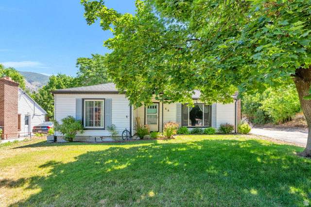 White siding exterior with dark trim windows and light blue shutters
