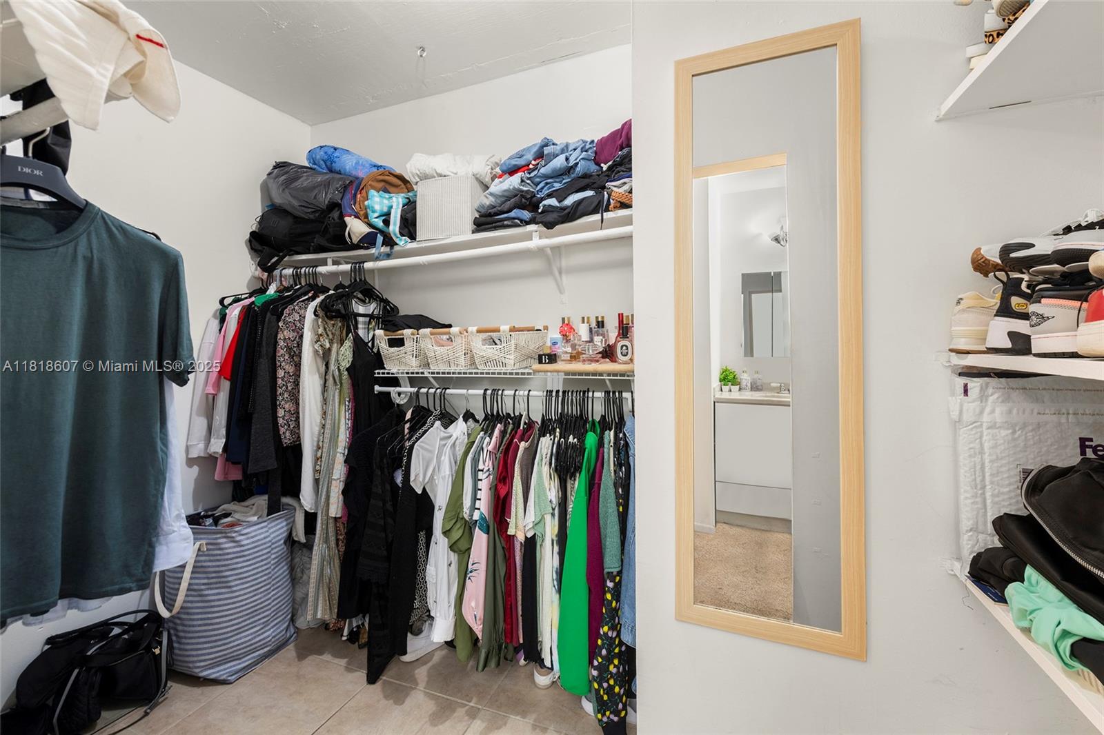 2350 Northeast 135th Street, Unit 1006 North Miami, FL 33181 - Photo 16 of 29 a view of walk in closet with clothes and shoes