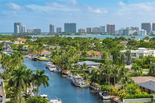 an aerial view of residential houses with outdoor space and a lake view