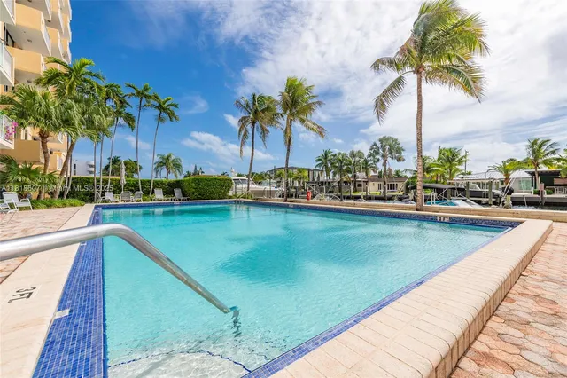 a swimming pool with outdoor seating and yard