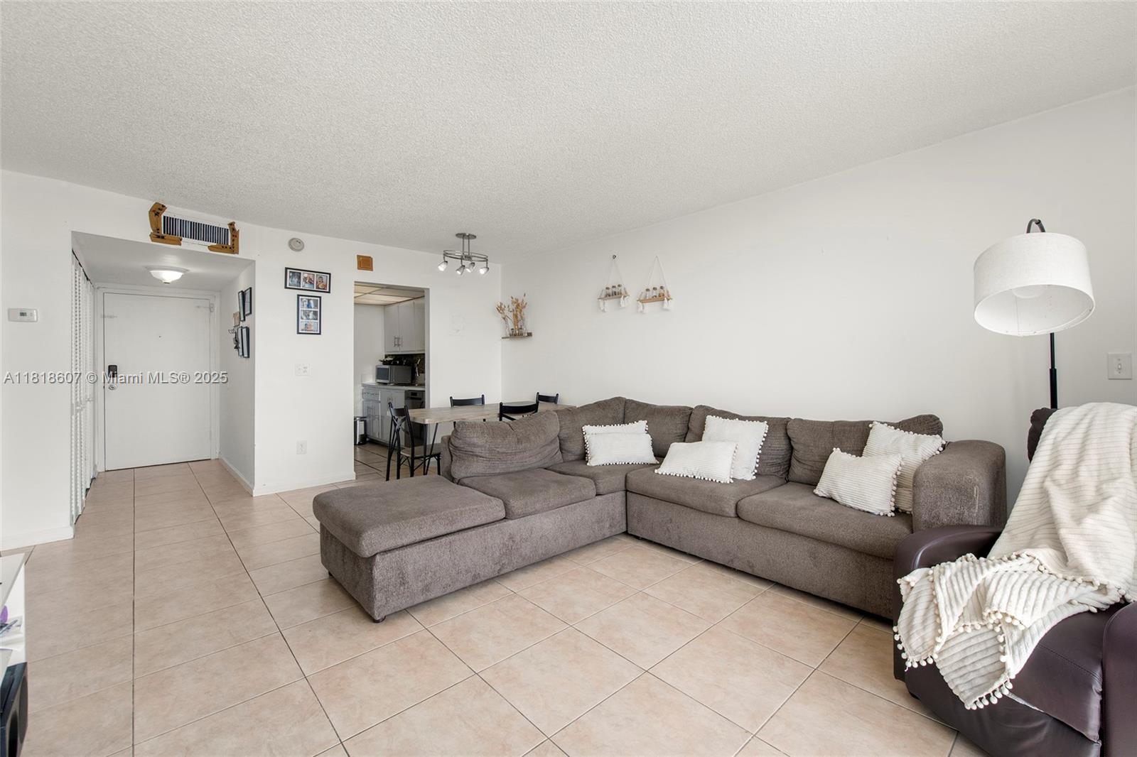 2350 Northeast 135th Street, Unit 1006 North Miami, FL 33181 - Photo 5 of 29 a living room with furniture and a couch
