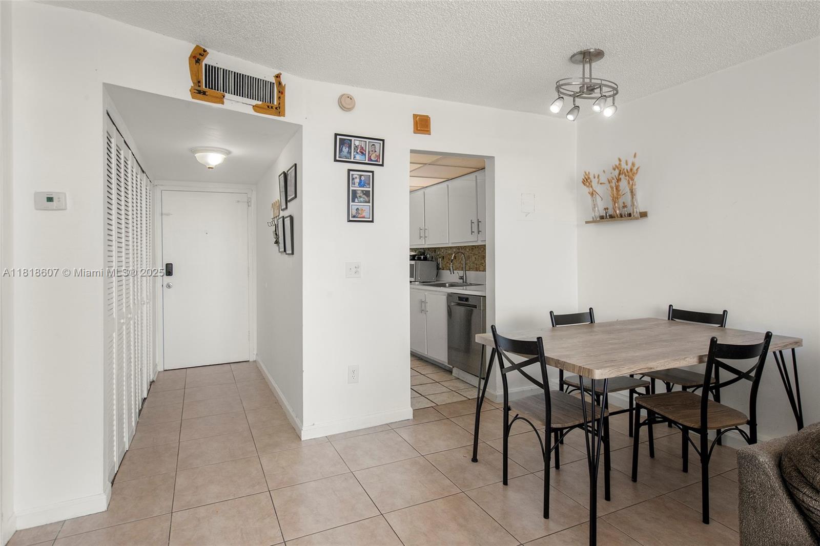2350 Northeast 135th Street, Unit 1006 North Miami, FL 33181 - Photo 7 of 29 a view of a dining room with furniture