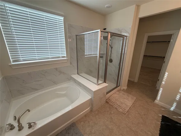 a bathroom with a bathtub and a shower