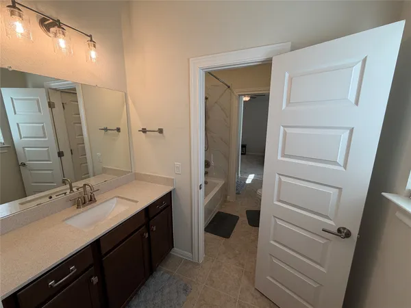 a bathroom with a double vanity sink a toilet and a mirror