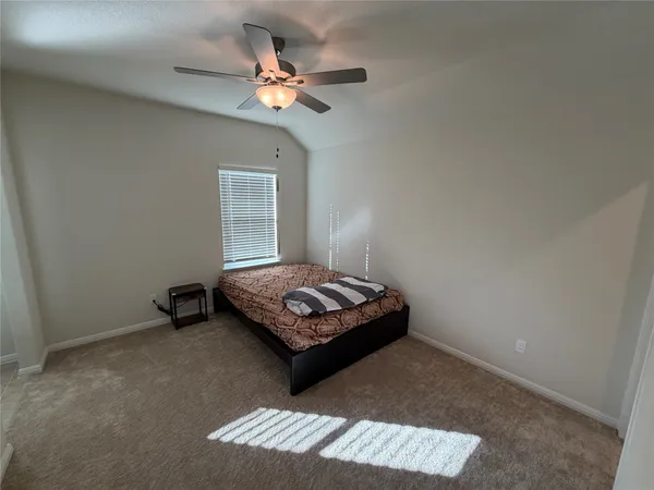 a living room with a couch and chandelier