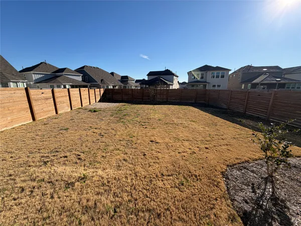 a view of wooden fence and a yard