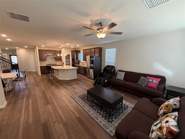 a living room with furniture and wooden floor