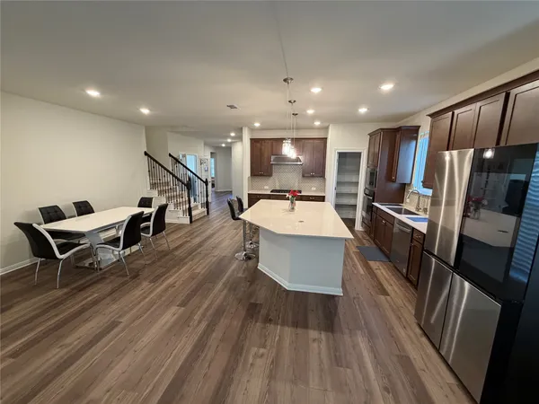 a large kitchen with a large window and stainless steel appliances