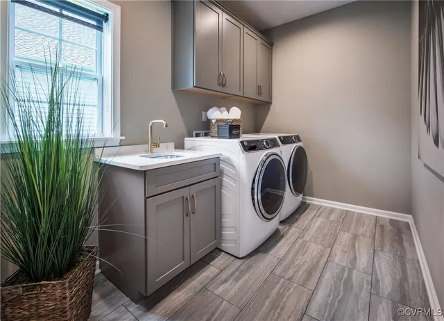 a utility room with sink dryer and washer