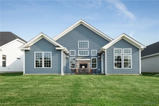 a view of a house with a yard and porch