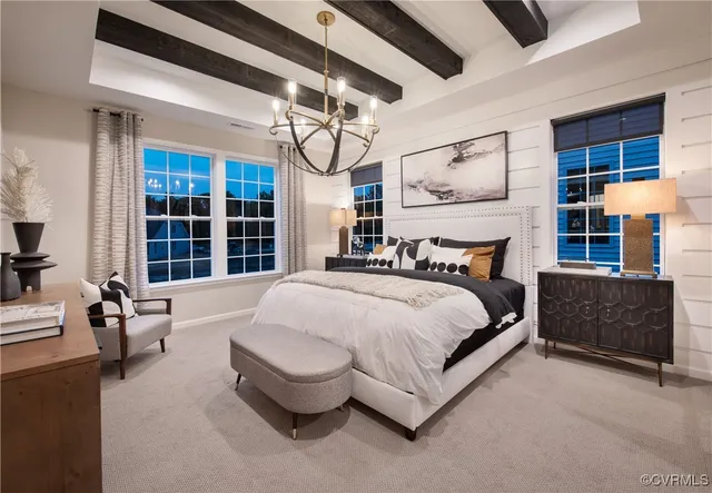a spacious bedroom with a bed and a large window