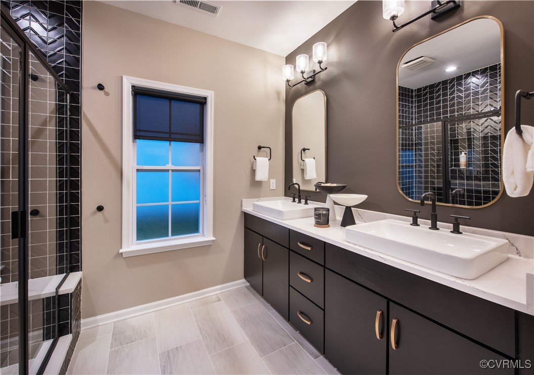 Undisclosed Address Chester, VA 23831 - Photo 10 of 30 a bathroom with a double vanity sink a two mirror and a shower