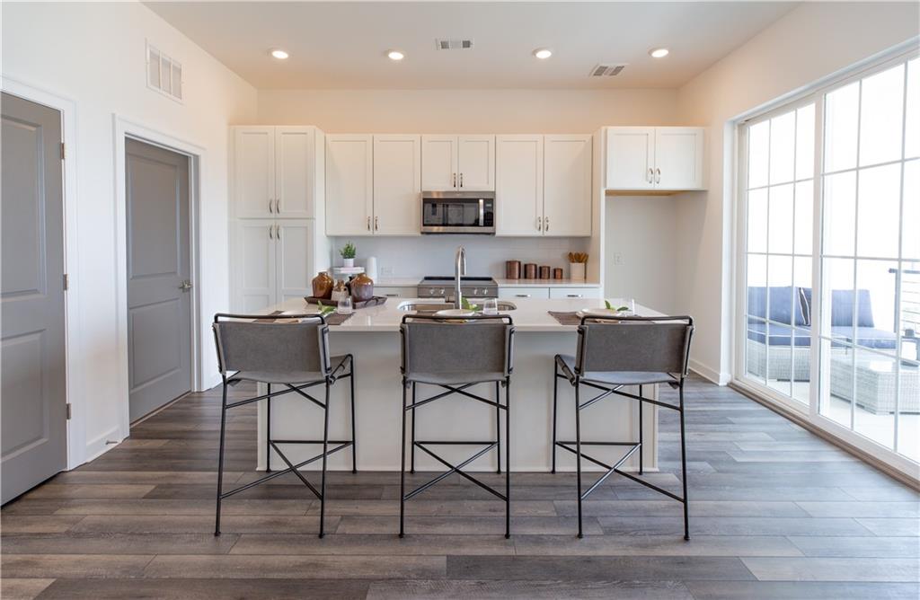 a dining room with furniture a wooden floor and a window