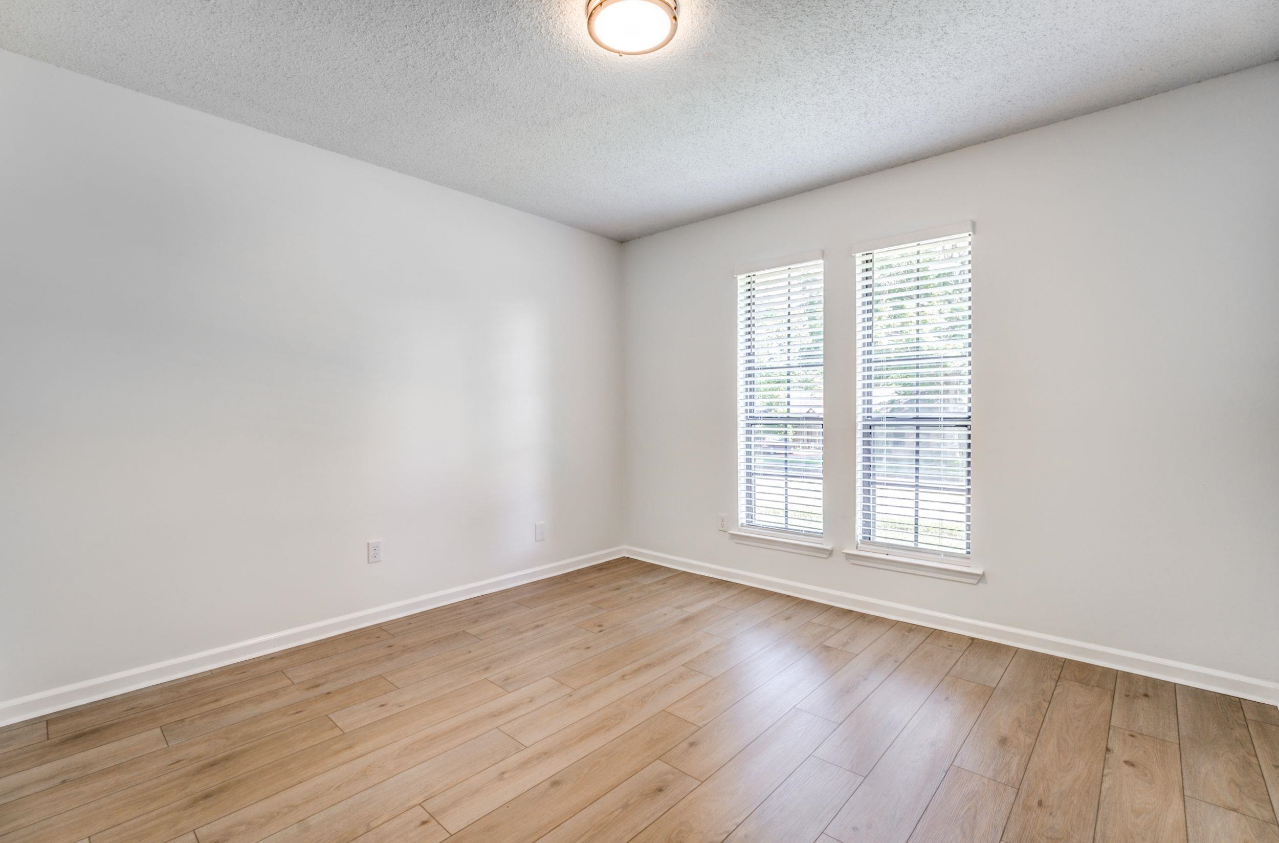 6710 Rockingham Road Memphis, TN 38141 - Photo 12 of 12 an empty room with wooden floor and windows