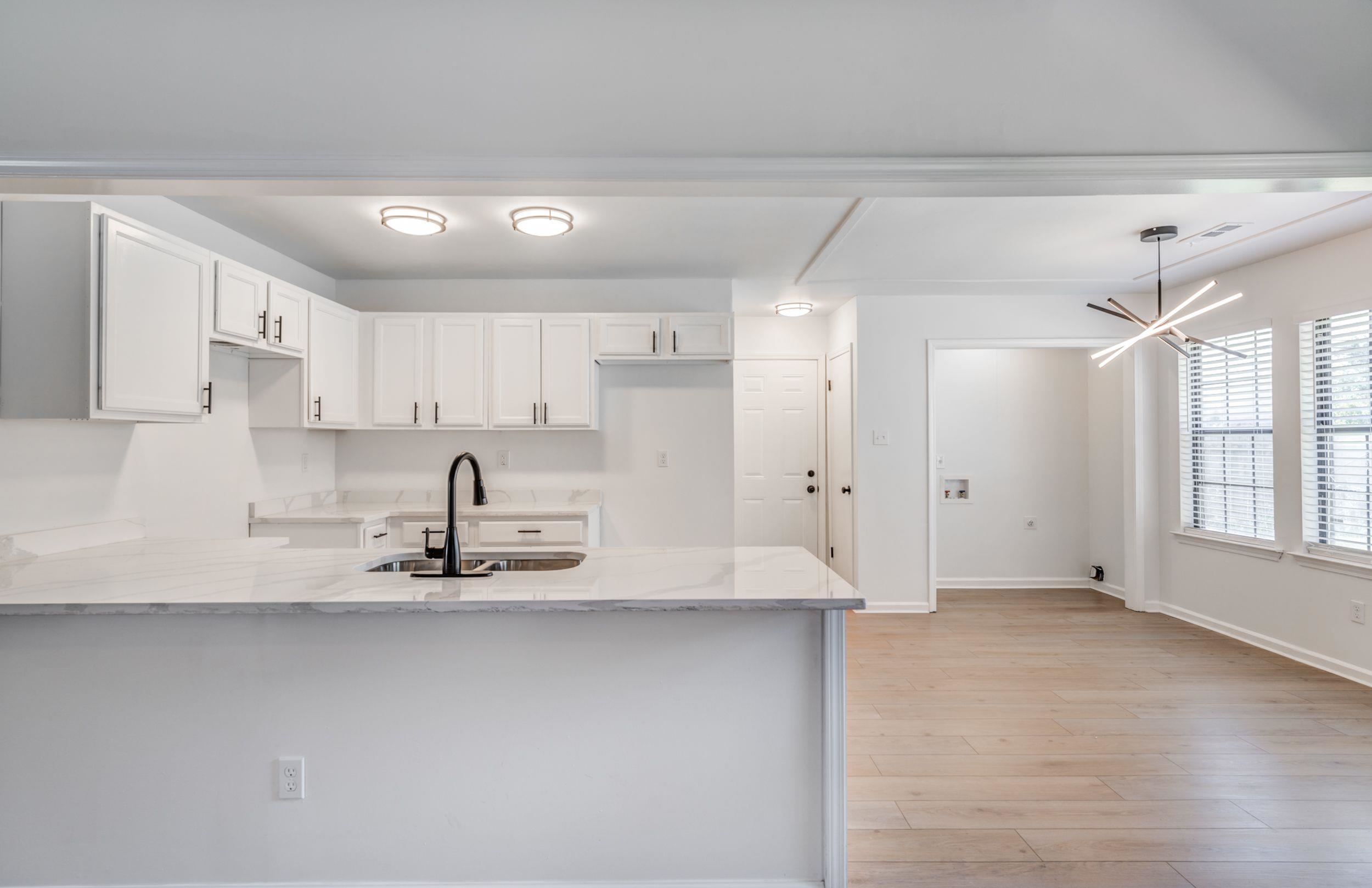 6710 Rockingham Road Memphis, TN 38141 - Photo 5 of 12 a large kitchen with white cabinets and a granite counter tops