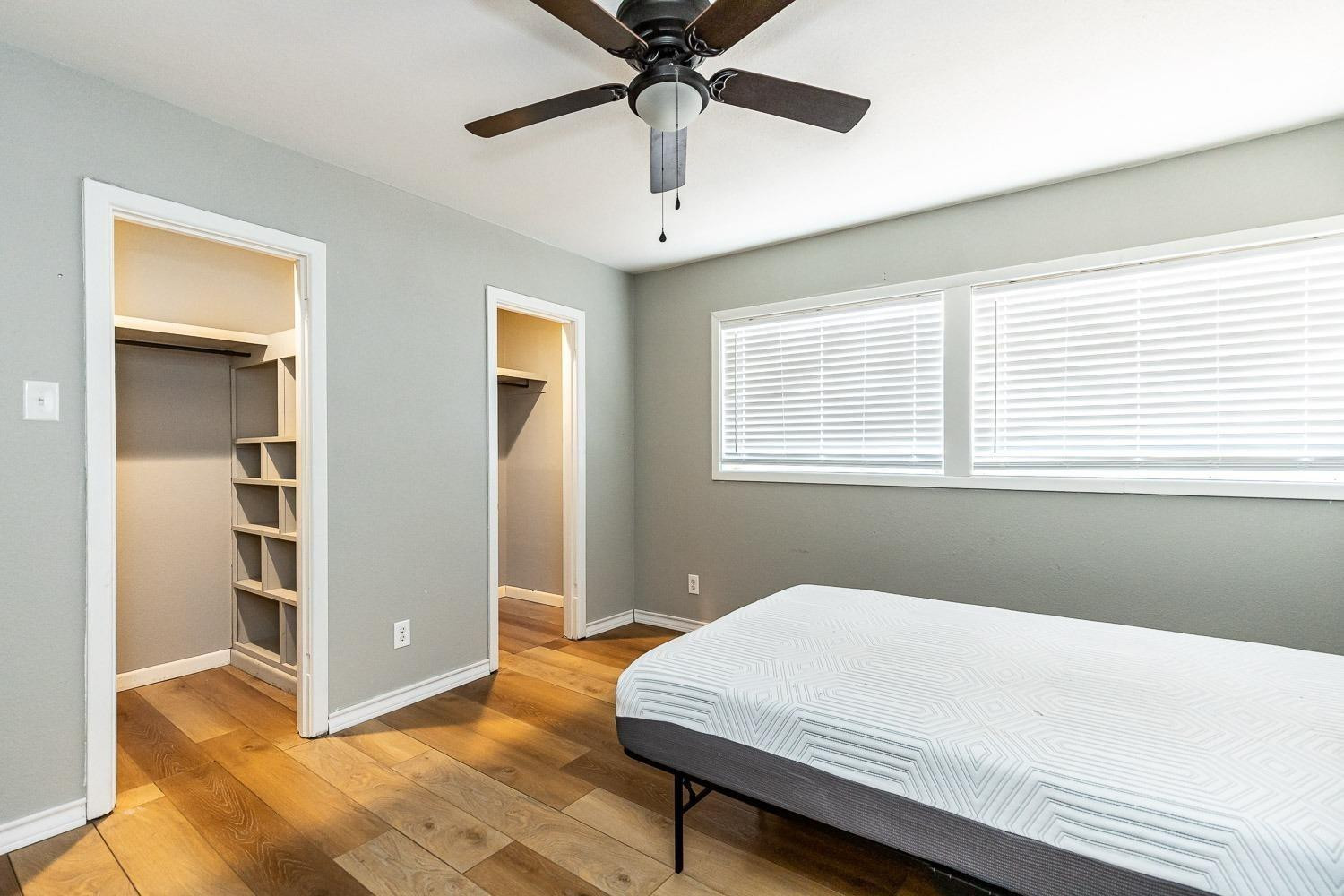 3411 42nd Street Lubbock, TX 79413 - Photo 17 of 33 a bedroom with a bed and a chandelier