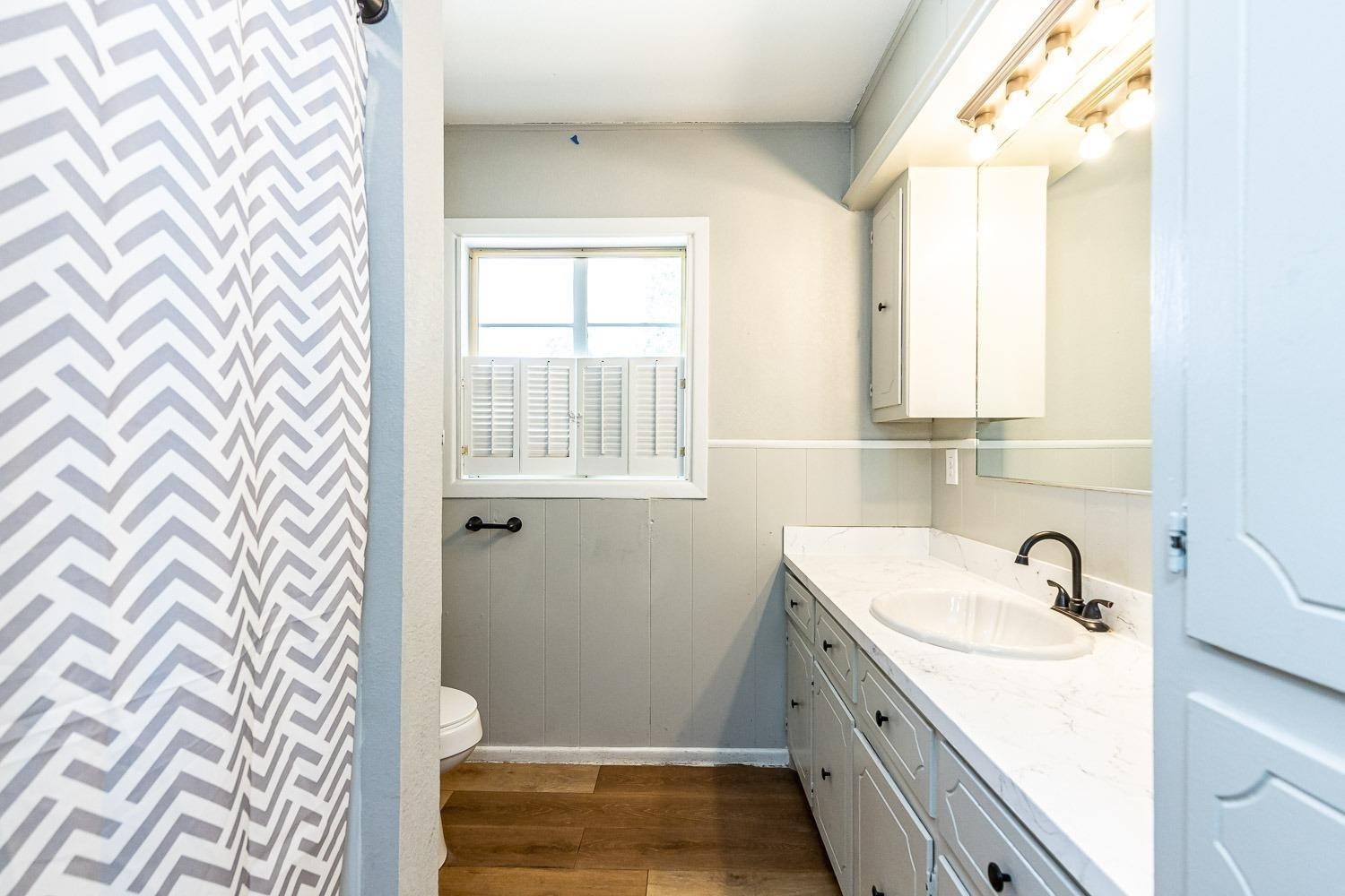 3411 42nd Street Lubbock, TX 79413 - Photo 19 of 33 a bathroom with a sink and a bathtub