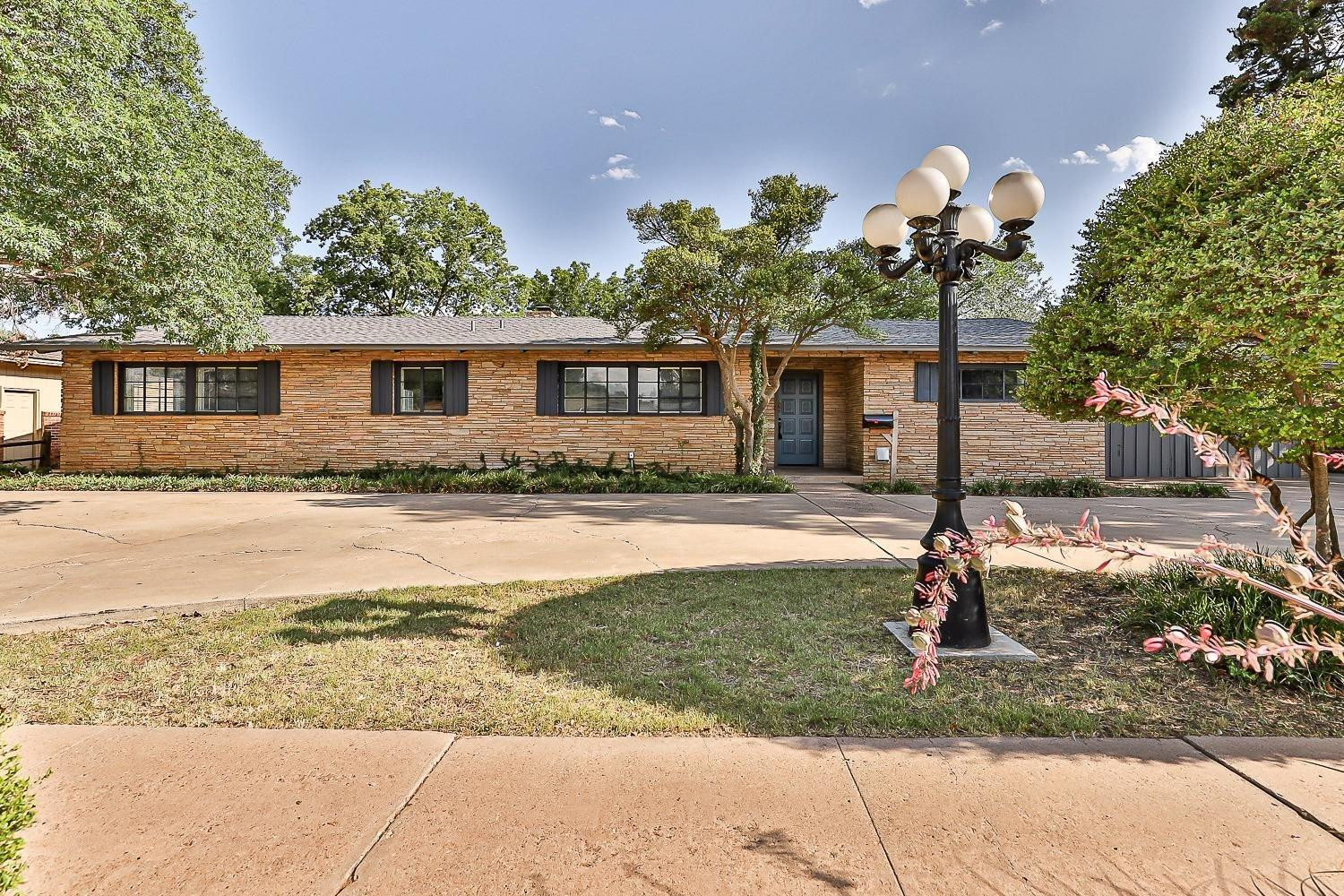 3411 42nd Street Lubbock, TX 79413 - Photo 2 of 33 a front view of house with yard and green space