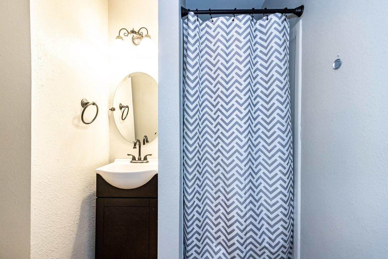 3411 42nd Street Lubbock, TX 79413 - Photo 22 of 33 a bathroom with a sink and a mirror