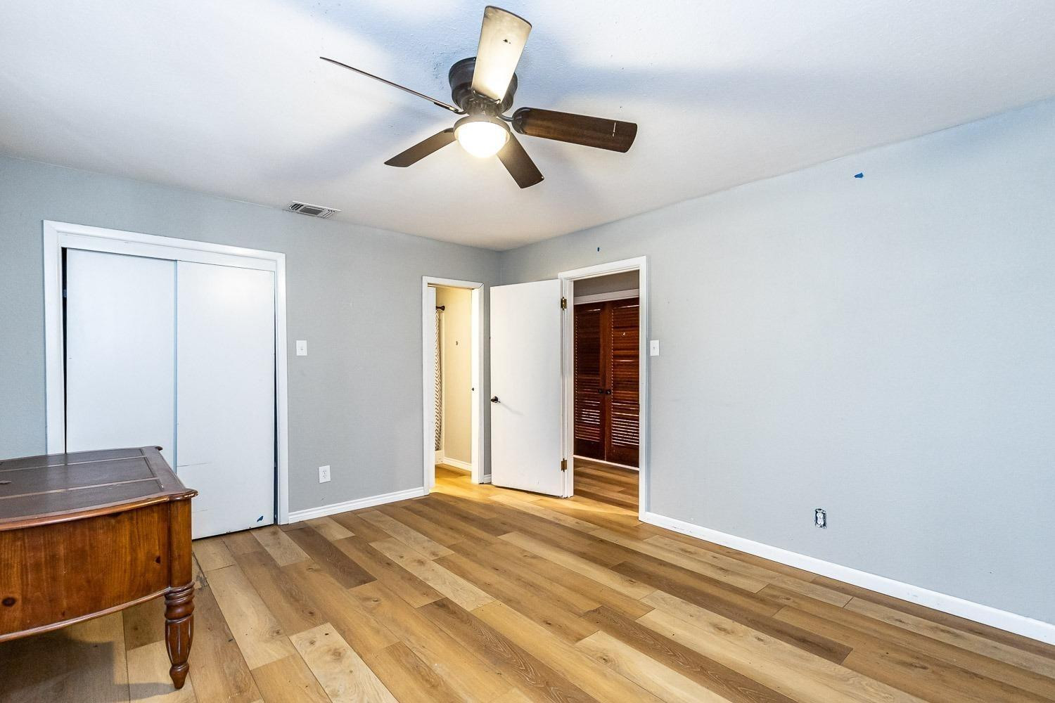 3411 42nd Street Lubbock, TX 79413 - Photo 23 of 33 a view of a livingroom with a chandelier fan and a window