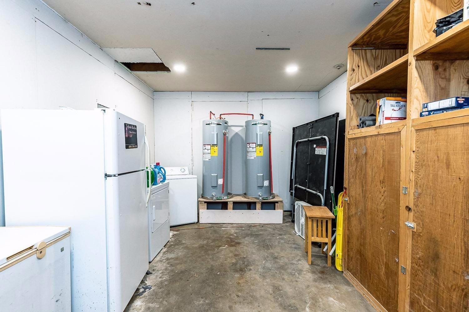 3411 42nd Street Lubbock, TX 79413 - Photo 26 of 33 a view of a hallway with furniture and a refrigerator