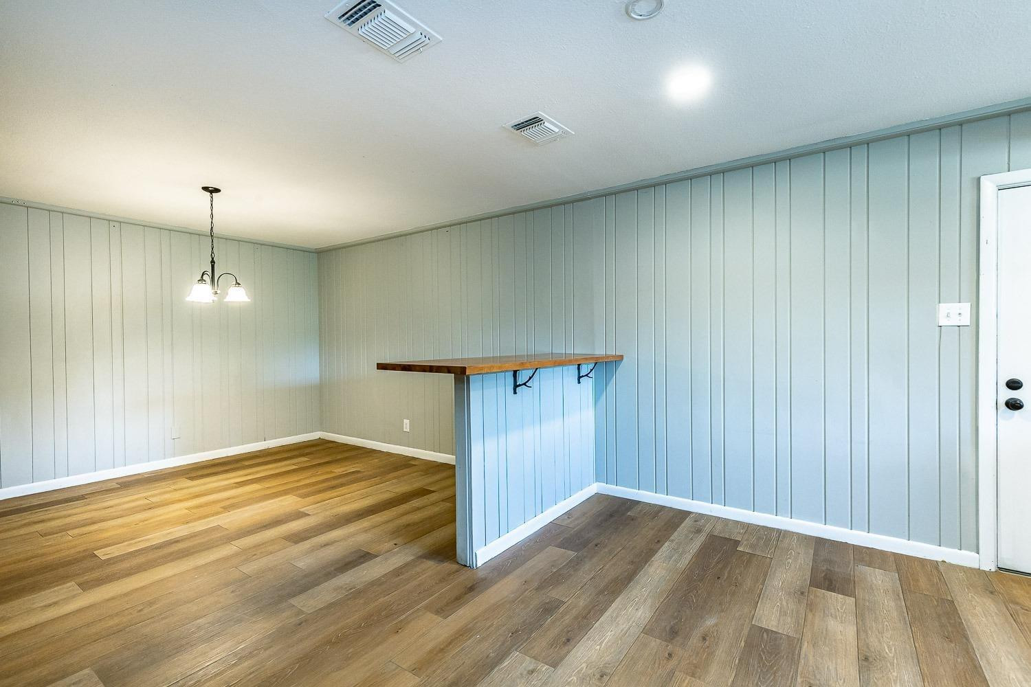 3411 42nd Street Lubbock, TX 79413 - Photo 27 of 33 an empty room with wooden floor door and windows