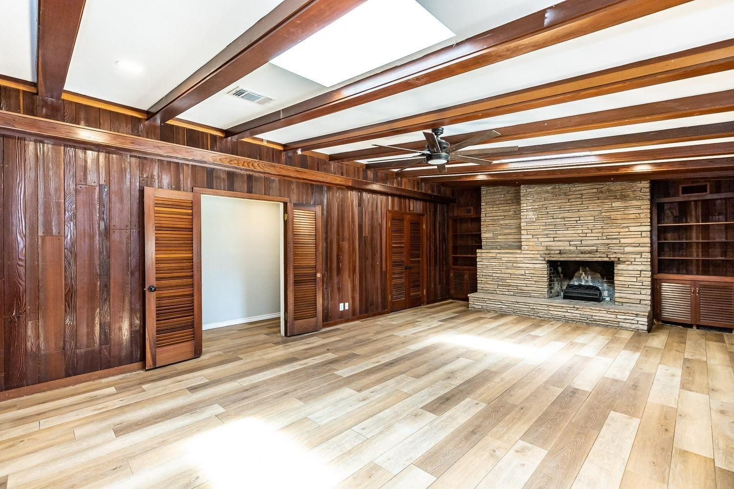 3411 42nd Street Lubbock, TX 79413 - Photo 33 of 33 a view of empty room with wooden floor and fireplace
