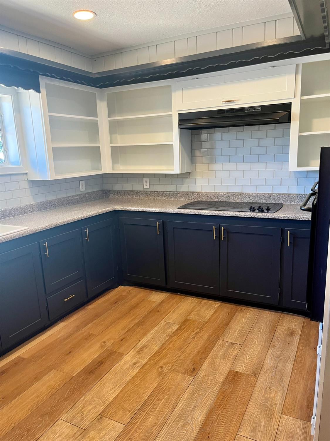 3411 42nd Street Lubbock, TX 79413 - Photo 4 of 33 a kitchen with wooden cabinets and a sink